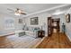 Inviting living room featuring a comfortable sectional sofa, stylish decor, and hardwood floors at 101 Goldston Dr, Carrboro, NC 27510