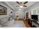 Cozy living room with comfortable seating, area rug, and ceiling fan at 101 Goldston Dr, Carrboro, NC 27510