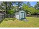 A white storage shed with green trim in a well-maintained backyard at 101 Goldston Dr, Carrboro, NC 27510