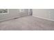Spacious bedroom featuring carpet floors, natural light, and neutral paint colors at 1018 Excite Ave, Morrisville, NC 27560
