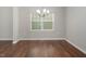 This dining area features hardwood floors, lots of natural light, and a decorative chandelier at 1018 Excite Ave, Morrisville, NC 27560