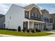 Side view of a two-story home with brick and vinyl siding, showcasing the well-kept landscaping at 1018 Excite Ave, Morrisville, NC 27560