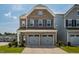 Charming brick home featuring a two-car garage, well-maintained lawn, and classic architectural details at 1018 Excite Ave, Morrisville, NC 27560