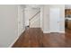 The home's hallway features hardwood floors, white walls, and a set of stairs at 1018 Excite Ave, Morrisville, NC 27560