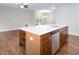 A kitchen island features a stainless steel dishwasher, wooden cabinets, a white countertop and a stainless steel faucet at 1018 Excite Ave, Morrisville, NC 27560