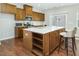 Well-equipped kitchen with a central island, stainless steel appliances, and hardwood floors at 1018 Excite Ave, Morrisville, NC 27560
