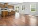 The open concept living room has hardwood floors, lots of natural light, and an island looking into the kitchen at 1018 Excite Ave, Morrisville, NC 27560