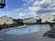 Community pool with lounge chairs and well-maintained surrounding common area with nearby residences at 1018 Excite Ave, Morrisville, NC 27560