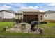 Spacious backyard features a stone patio with an outdoor dining area and grill at 1040 Bellenden Dr, Durham, NC 27713