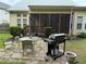 View of backyard with patio, outdoor dining set, grill, and view of the screened porch at 1040 Bellenden Dr, Durham, NC 27713