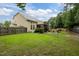 Expansive backyard features a well-maintained lawn, a stone patio with a grill and a screened porch at 1040 Bellenden Dr, Durham, NC 27713