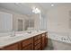 Bathroom featuring a double vanity, soaking tub, and a separate shower at 1040 Bellenden Dr, Durham, NC 27713