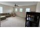 Spacious carpeted bonus room with three windows, ceiling fan, sectional sofa, and additional seating at 1040 Bellenden Dr, Durham, NC 27713