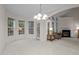 Bright dining area with many windows, fireplace, and chandelier lighting at 1040 Bellenden Dr, Durham, NC 27713