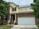 Charming two-story home featuring a stone facade, attached two-car garage, and well-maintained landscaping at 1040 Bellenden Dr, Durham, NC 27713