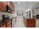Spacious kitchen with wooden cabinets, granite countertops, and stainless steel appliances at 1040 Bellenden Dr, Durham, NC 27713