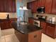 Stylish kitchen with an island, dark granite countertops, stainless steel appliances, and ample cabinet space at 1040 Bellenden Dr, Durham, NC 27713