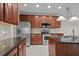 Kitchen featuring stainless steel appliances, granite countertops, and wood cabinets at 1040 Bellenden Dr, Durham, NC 27713