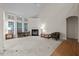 Bright living room featuring a fireplace, large windows, and carpeted flooring at 1040 Bellenden Dr, Durham, NC 27713