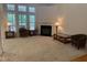 Bright and inviting living room featuring carpet, a fireplace, and large windows providing ample natural light at 1040 Bellenden Dr, Durham, NC 27713