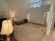 Spacious living room with high ceilings, carpet, a fireplace, and large windows for natural light at 1040 Bellenden Dr, Durham, NC 27713