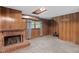 Spacious basement area with a brick fireplace, wood paneling, and plenty of room for storage at 106 Lattimore Ln, Durham, NC 27713