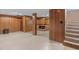 Spacious finished basement with wood paneling, fireplace, and stairway for extra living space at 106 Lattimore Ln, Durham, NC 27713