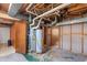 Spacious basement area with visible pipes and wooden door, potential for storage or customization at 106 Lattimore Ln, Durham, NC 27713