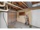 Unfinished basement with a water heater, piping, and plenty of room for storage at 106 Lattimore Ln, Durham, NC 27713