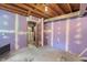 Unfinished basement with primed walls and visible ceiling beams, offering potential for customization at 106 Lattimore Ln, Durham, NC 27713