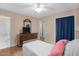 This quaint bedroom features a ceiling fan, wood floors, and a neutral color palette at 106 Lattimore Ln, Durham, NC 27713