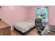 This cozy bedroom features hardwood floors, a comfortable work space, and good natural light at 106 Lattimore Ln, Durham, NC 27713