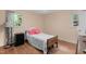 This cozy bedroom offers natural light from the windows and features hardwood flooring at 106 Lattimore Ln, Durham, NC 27713