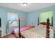 Charming bedroom featuring two beds, hardwood floors, and plenty of natural light at 106 Lattimore Ln, Durham, NC 27713