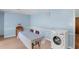 Open dining area featuring light blue walls, a table, and a modern washer at 106 Lattimore Ln, Durham, NC 27713