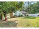 Landscaped front yard with a traditional home featuring brick accents and a tidy lawn at 106 Lattimore Ln, Durham, NC 27713