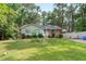 Traditional home with a well-kept lawn, complemented by lush trees and a white fence at 106 Lattimore Ln, Durham, NC 27713