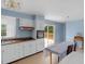Bright kitchen with white cabinets, wood countertops, a view of the deck through the sliding glass door at 106 Lattimore Ln, Durham, NC 27713