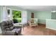 Comfortable living room with a large window showcasing a lush outdoor view and cozy seating at 106 Lattimore Ln, Durham, NC 27713