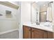 Bathroom featuring a wooden vanity with a sink, a mirror, and a walk-in closet with wire shelving at 1090 Indigo Ridge Pl, Cary, NC 27519