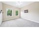 Bedroom featuring plush carpet, two windows, and neutral walls at 1090 Indigo Ridge Pl, Cary, NC 27519