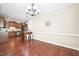 Open concept dining area with hardwood floors, modern lighting and a kitchen view at 1090 Indigo Ridge Pl, Cary, NC 27519
