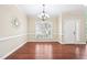 Bright dining room with hardwood flooring, a modern chandelier, and a large window at 1090 Indigo Ridge Pl, Cary, NC 27519