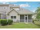 Home exterior featuring a screened-in porch, and lush greenery at 1090 Indigo Ridge Pl, Cary, NC 27519