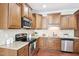 Well-equipped kitchen with stainless steel appliances and granite countertops at 1090 Indigo Ridge Pl, Cary, NC 27519