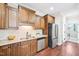 Traditional kitchen features wooden cabinets, stainless steel appliances, and granite countertops at 1090 Indigo Ridge Pl, Cary, NC 27519