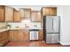 Traditional kitchen features wooden cabinets, stainless steel appliances, and granite countertops at 1090 Indigo Ridge Pl, Cary, NC 27519