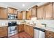 Modern kitchen with stainless steel appliances, granite countertops, and tile backsplash at 1090 Indigo Ridge Pl, Cary, NC 27519