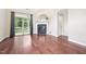Bright living room with hardwood floors, fireplace, and sliding door access to the outside at 1090 Indigo Ridge Pl, Cary, NC 27519