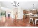 Open floor plan with living room, kitchen, and dining area connected by hardwood floors at 1090 Indigo Ridge Pl, Cary, NC 27519
